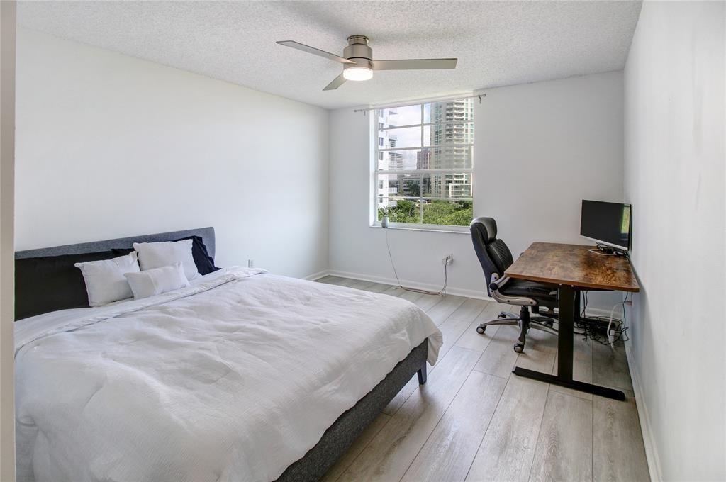520 Southeast 5th Avenue, Unit 2605 Fort Lauderdale, FL 33301 - Photo 19 of 38 a bedroom with a bed and a desk