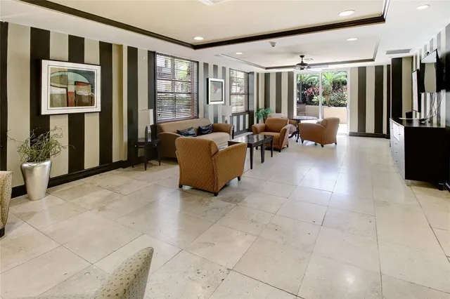a living room with furniture and large windows