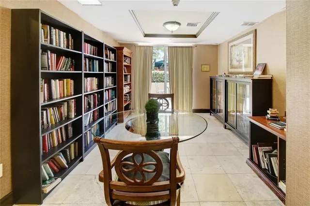 a room with lots of furniture and a book shelf