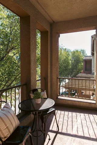 a view of a balcony with chairs
