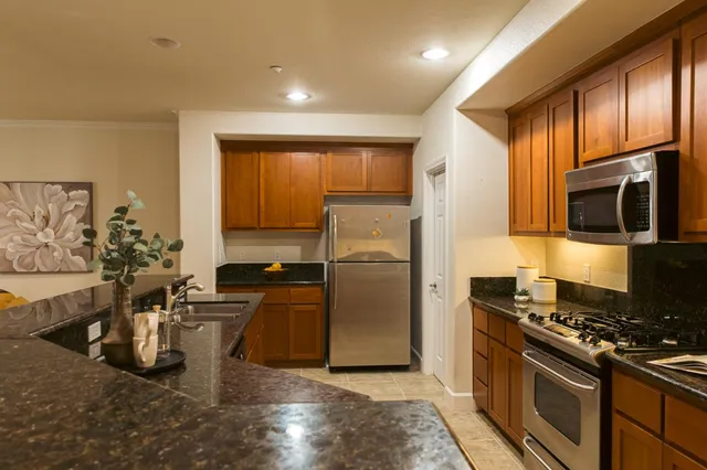 a kitchen with a sink appliances and cabinets