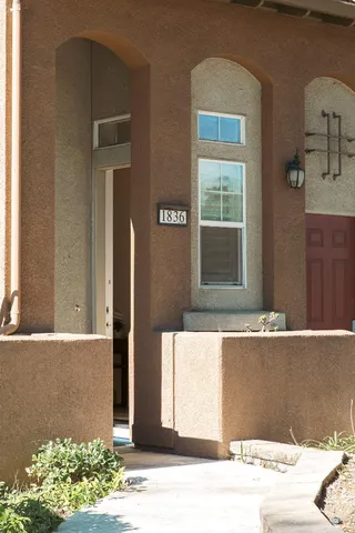 a view of a patio with couches table and chairs and potted plants