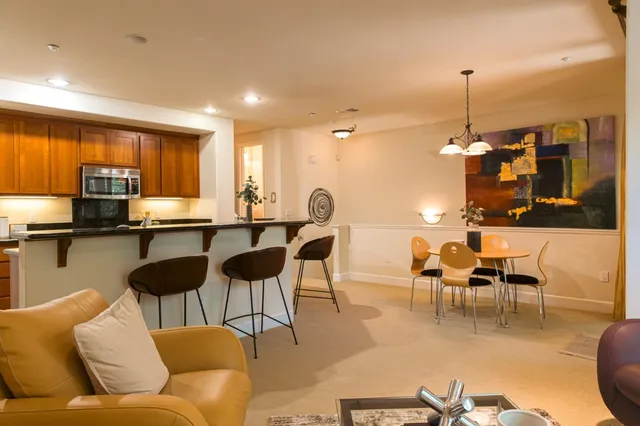 a living room with furniture a dining table and chairs