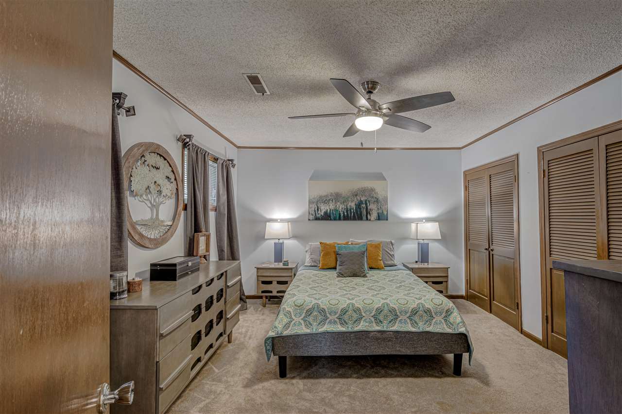 1631 Cranford Road Memphis, TN 38117 - Photo 13 of 21 a bedroom with a large bed and a chandelier