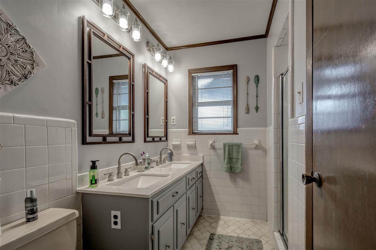 1631 Cranford Road Memphis, TN 38117 - Photo 15 of 21 a bathroom with a granite countertop sink a mirror and a shower