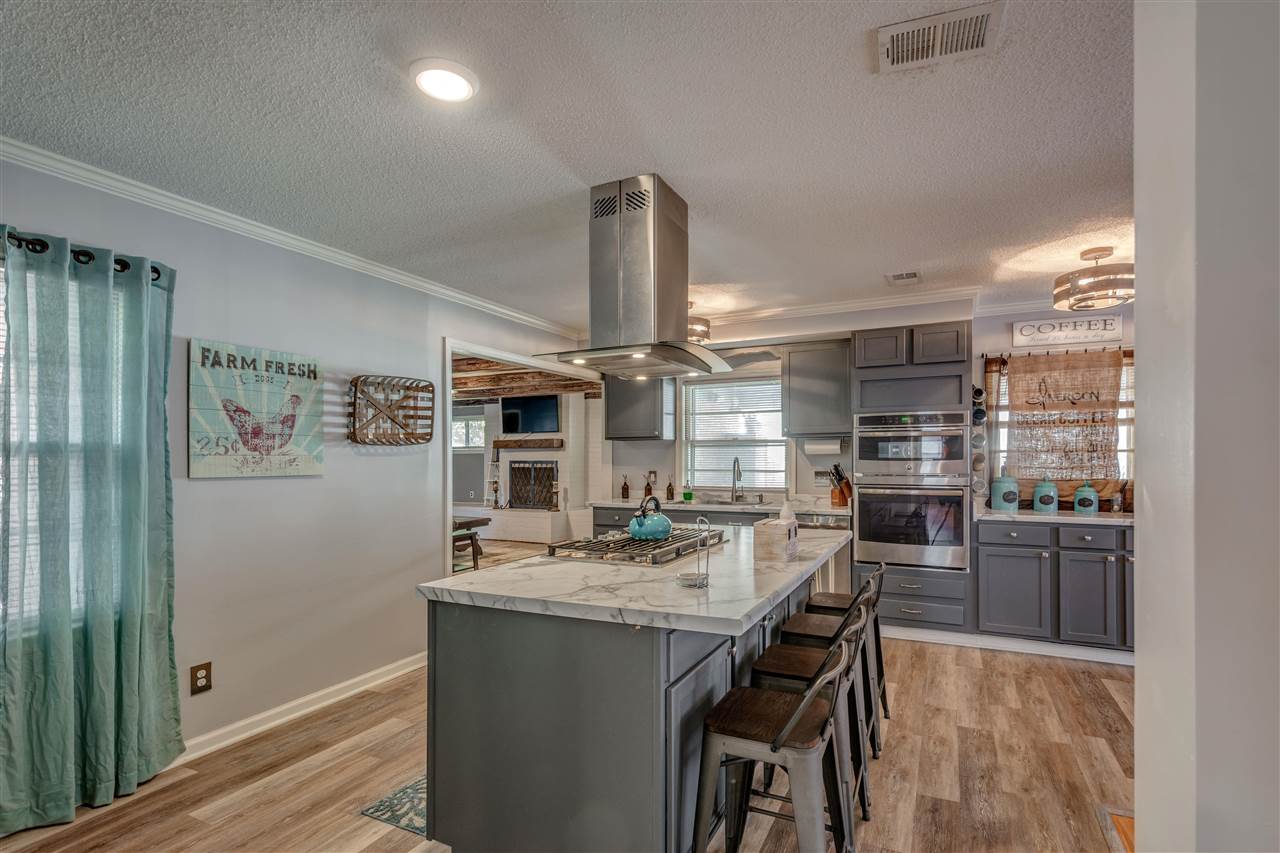 1631 Cranford Road Memphis, TN 38117 - Photo 8 of 21 a kitchen with refrigerator and chairs
