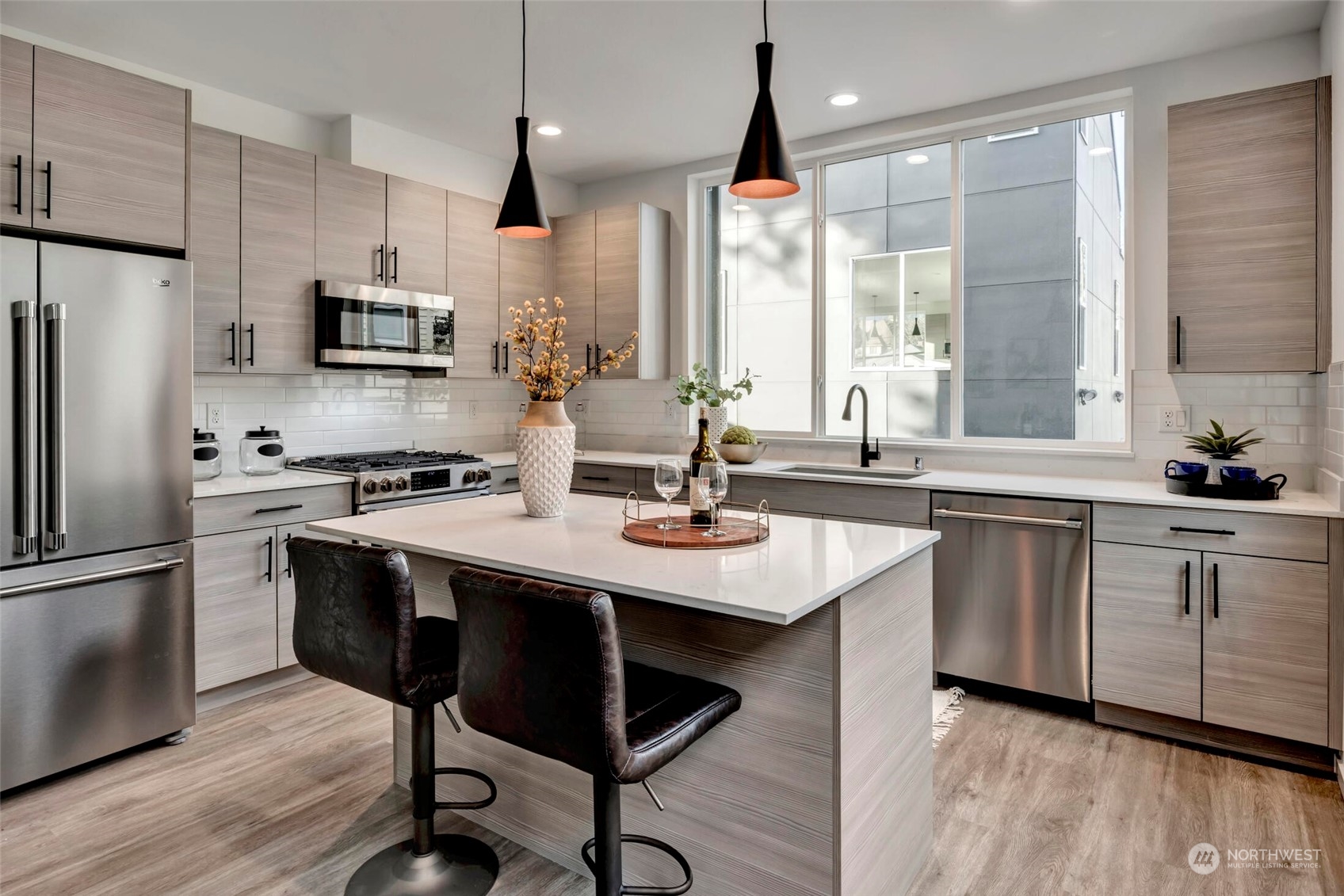 4024 Midvale Avenue North Seattle, WA 98103 - Photo 5 of 26 a kitchen with stainless steel appliances a sink a stove a refrigerator and cabinets
