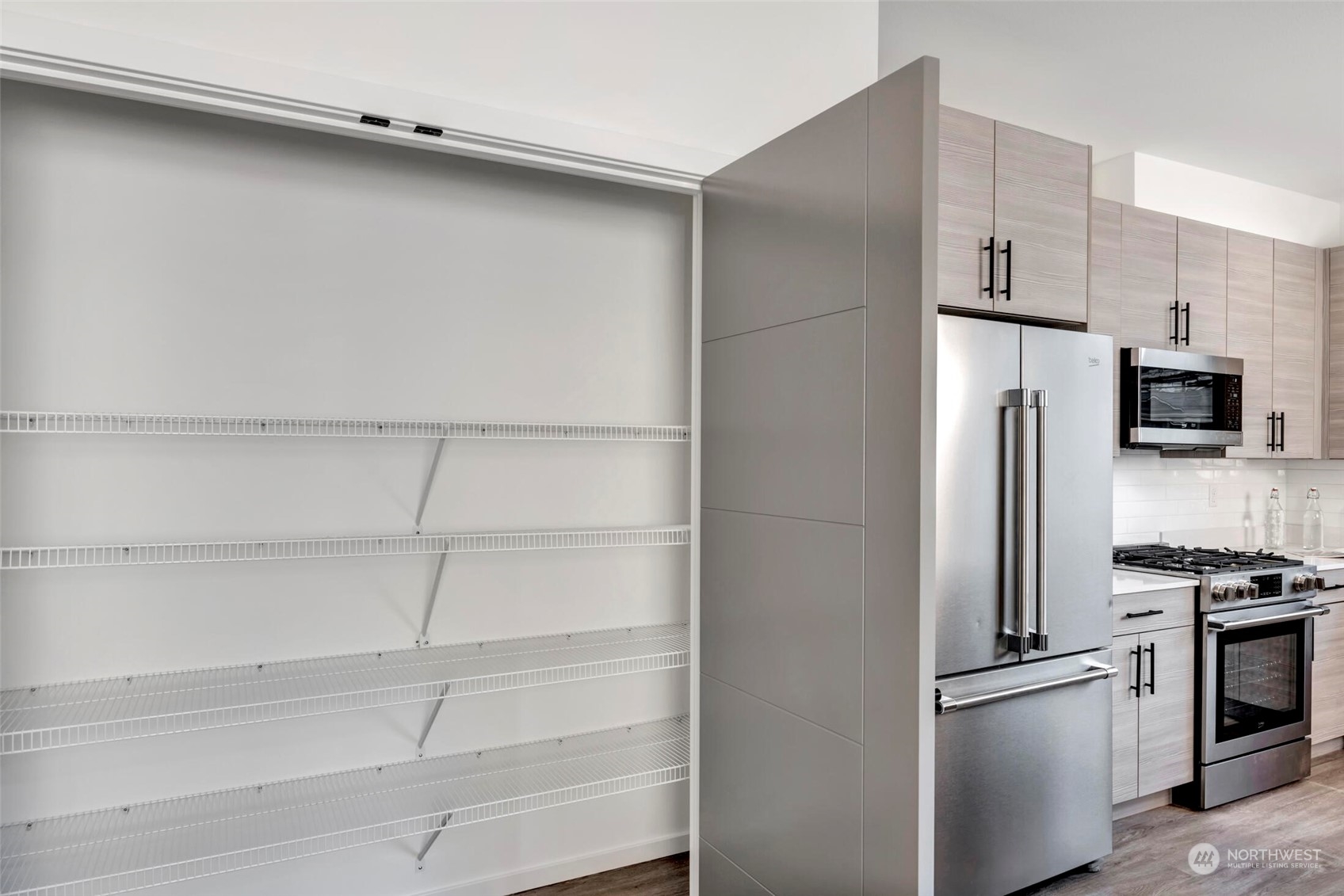 4024 Midvale Avenue North Seattle, WA 98103 - Photo 9 of 26 a metallic refrigerator freezer and a stove sitting inside of a kitchen