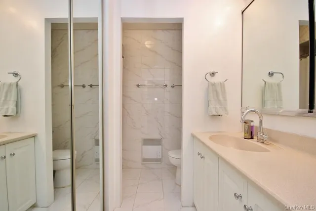 a bedroom with a bed table chair and a window
