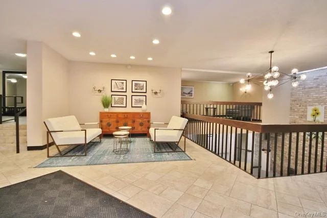 a living room with furniture and a chandelier