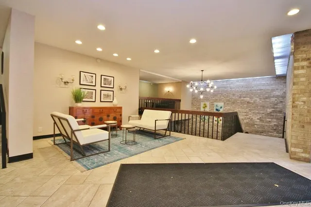 a living room with couches and kitchen view