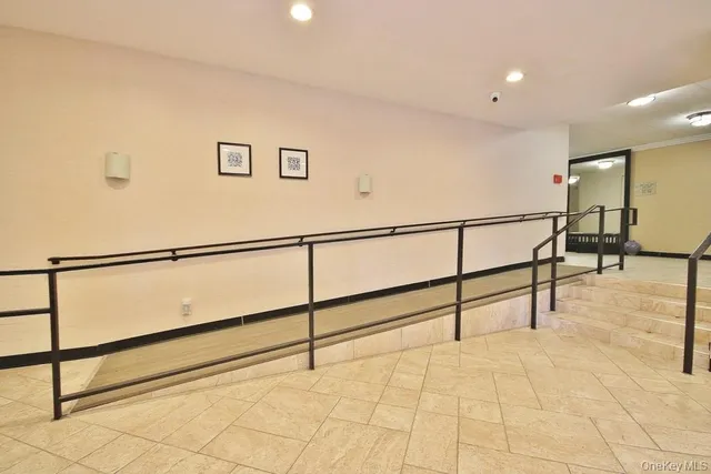 a living room with furniture and a stairs