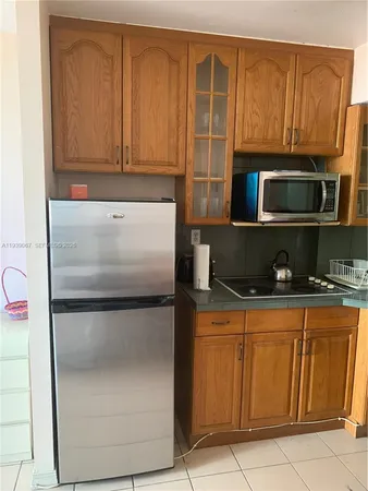 a kitchen with stainless steel appliances granite countertop a refrigerator and a stove top oven