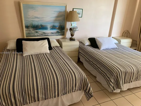 a bedroom with double sink and a window