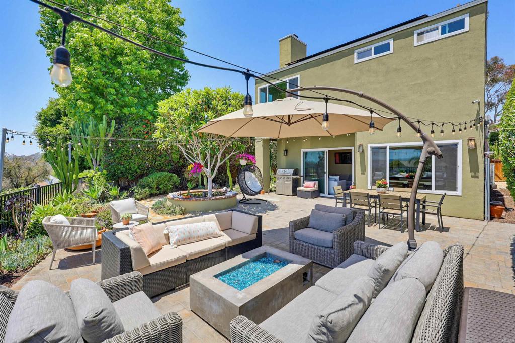 2756 Southampton Road Carlsbad, CA 92010 - Photo 14 of 40 a view of a patio with couches and chairs under an umbrella