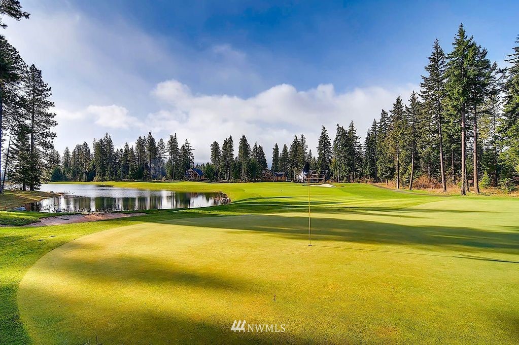 210 Clearwater Loop, Unit 2 Ronald, WA 98940 - Photo 24 of 35 a view of swimming pool with lawn chairs and large trees