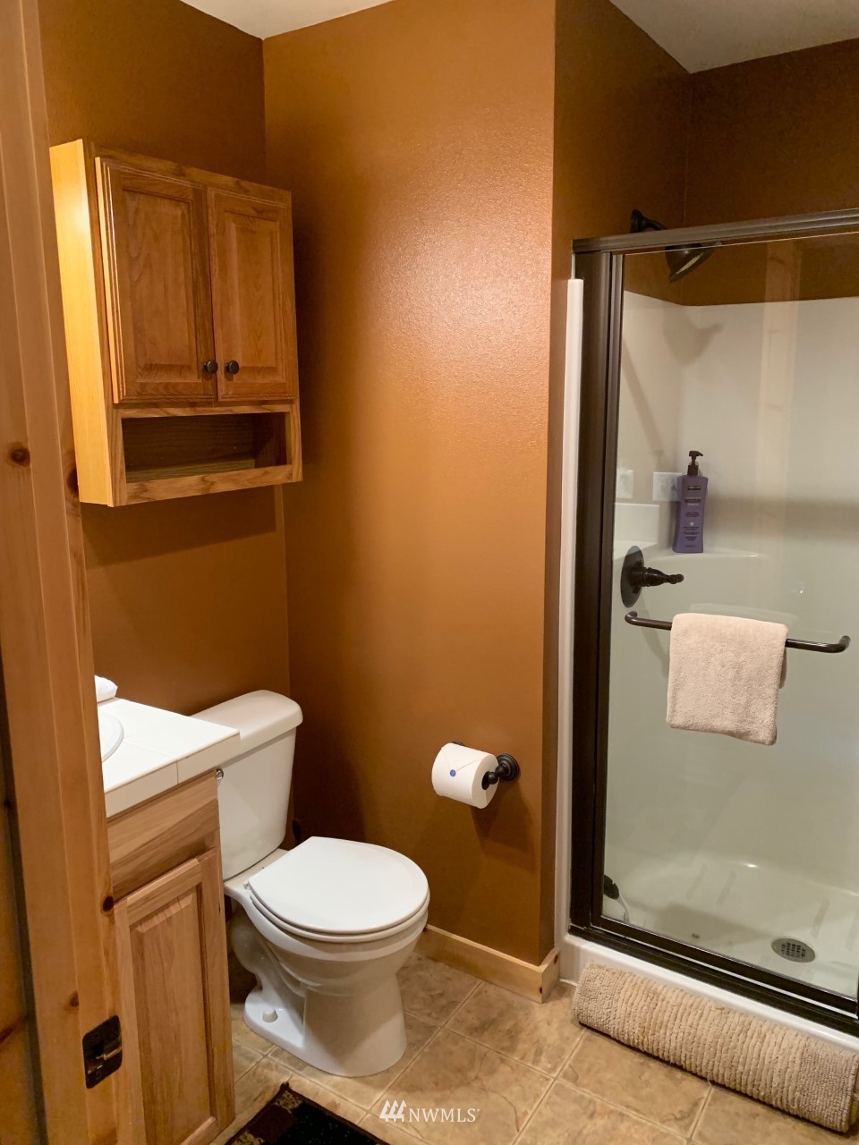 210 Clearwater Loop, Unit 2 Ronald, WA 98940 - Photo 8 of 35 a white toilet sitting next to a bathroom sink and vanity