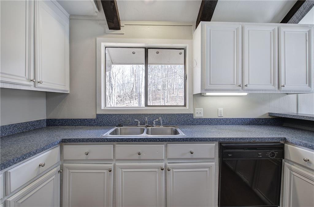 30 Tamarack Court Jasper, GA 30143 - Photo 14 of 70 a kitchen with granite countertop white cabinets sink and window
