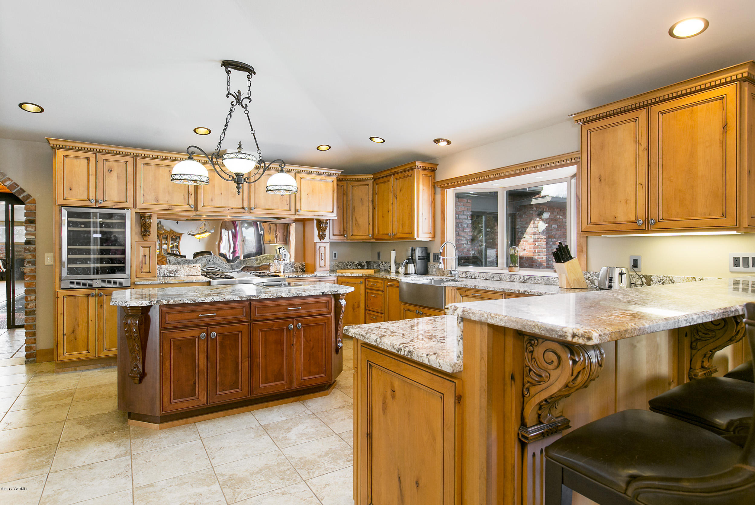 10709 Estes Road Yakima, WA 98908 - Photo 8 of 40 a kitchen with stainless steel appliances granite countertop a sink and cabinets