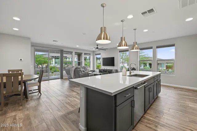 a bathroom with a granite countertop tub shower and sink