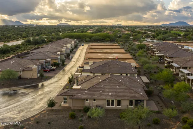 a view of a patio with a table and chairs under an umbrella