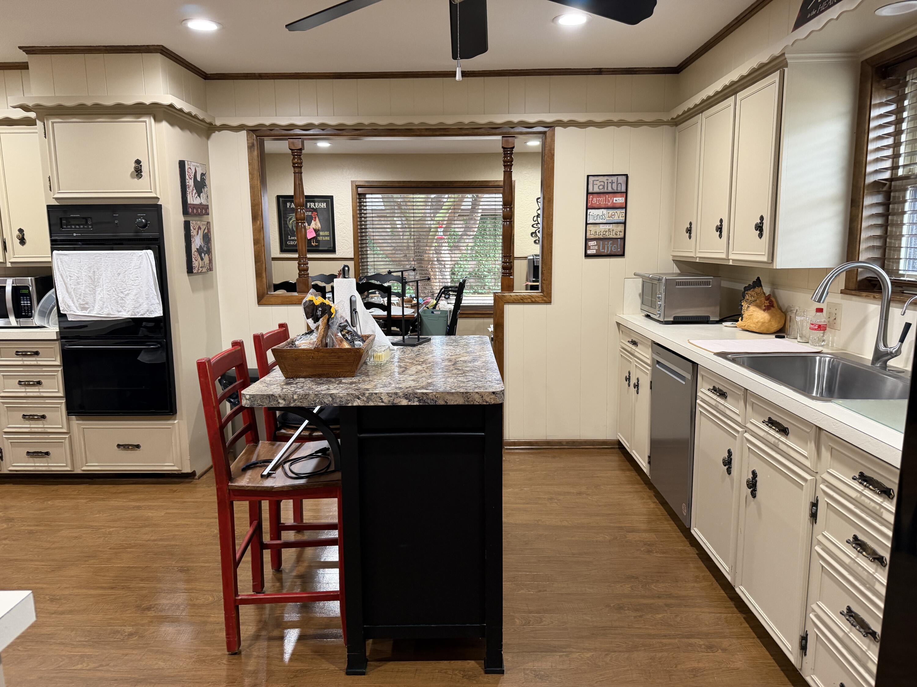 1603 South 8th Street Lamesa, TX 79331 - Photo 6 of 39 a kitchen with stainless steel appliances granite countertop a stove a sink and a microwave