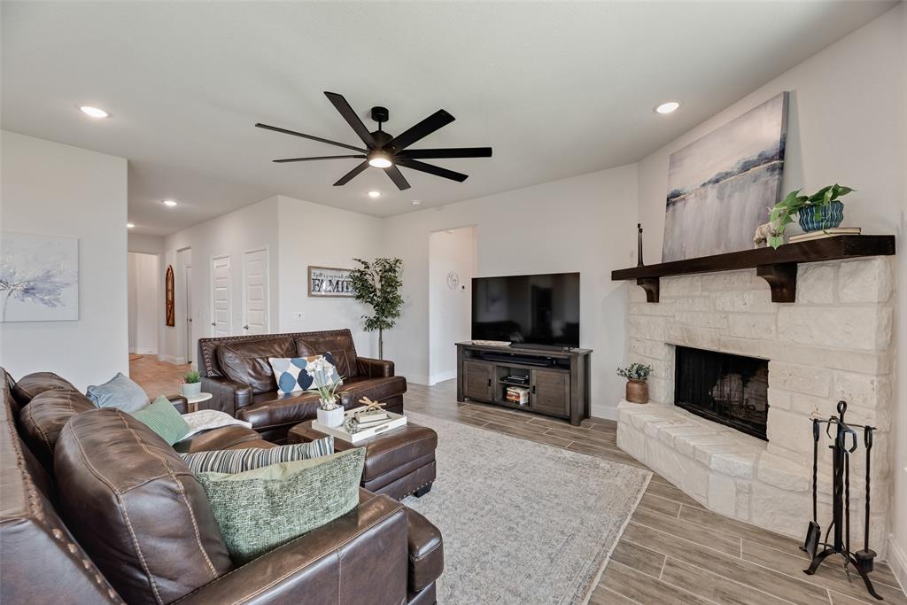 645 Mb Way South Pilot Point, TX 76258 - Photo 8 of 37 Spacious living room anchored by a beautiful stone fireplace, with plenty of room to gather and get cozy.