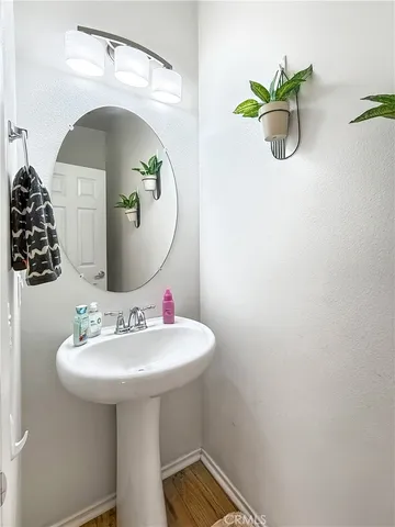 a bathroom with a sink a mirror and vanity