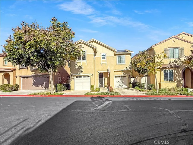 a front view of a house with a road