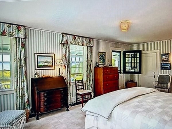 550 Chappaquonsett Road, Unit 1 Tisbury, MA 02568 - Photo 5 of 8 a bedroom with a bed and a closet