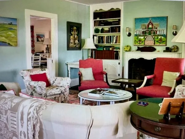 a living room with furniture and a book shelf
