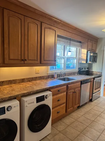 a kitchen with stainless steel appliances granite countertop a sink and cabinets