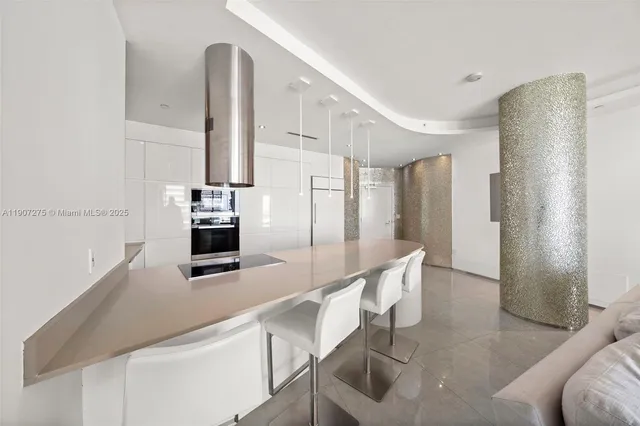 a kitchen with stainless steel appliances granite countertop a sink and a refrigerator