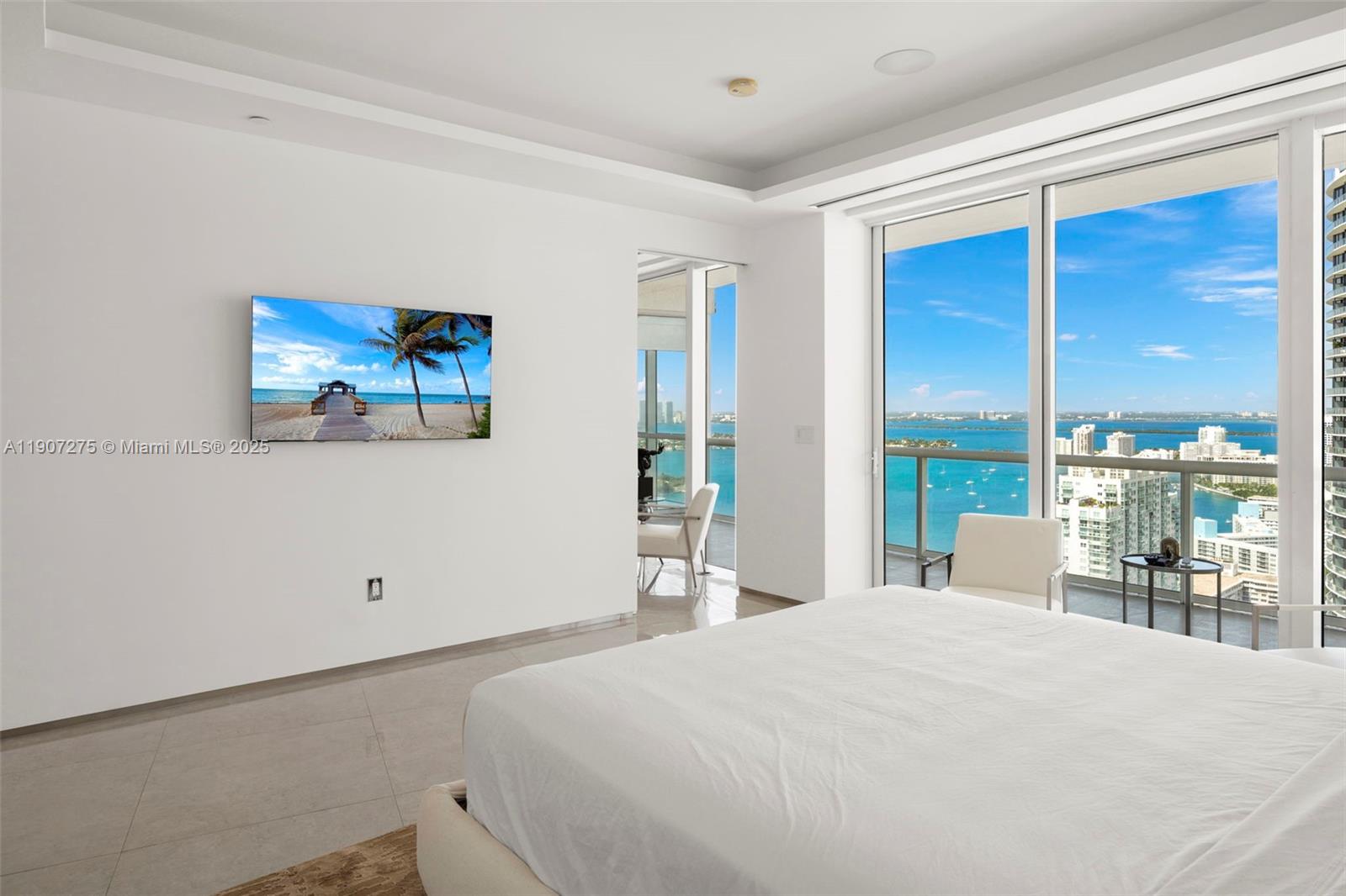 450 Alton Road, Unit PH4104 Miami Beach, FL 33139 - Photo 21 of 84 a bedroom with a large bed and a large window