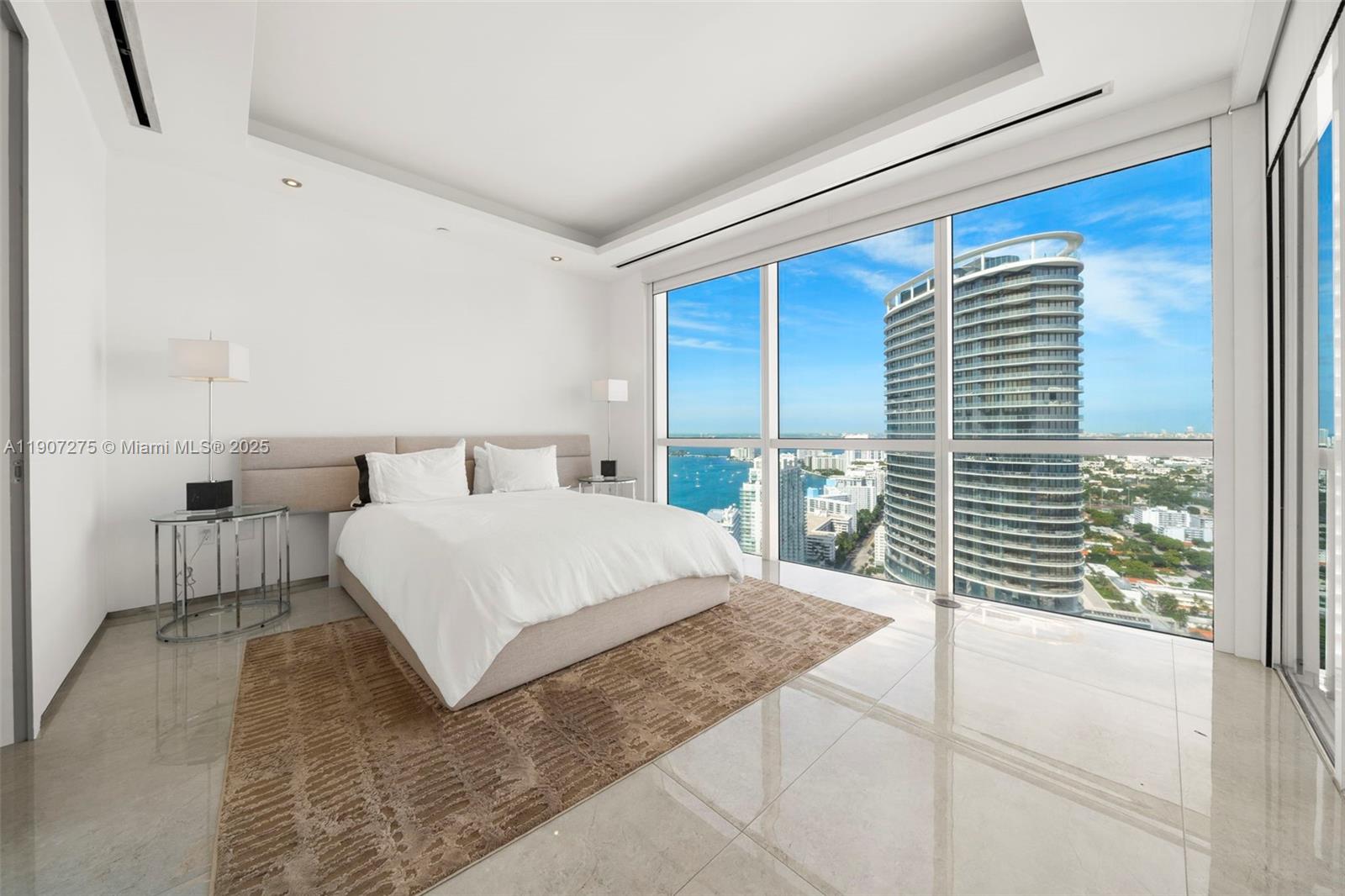 450 Alton Road, Unit PH4104 Miami Beach, FL 33139 - Photo 37 of 84 a bedroom with a large bed and a large window