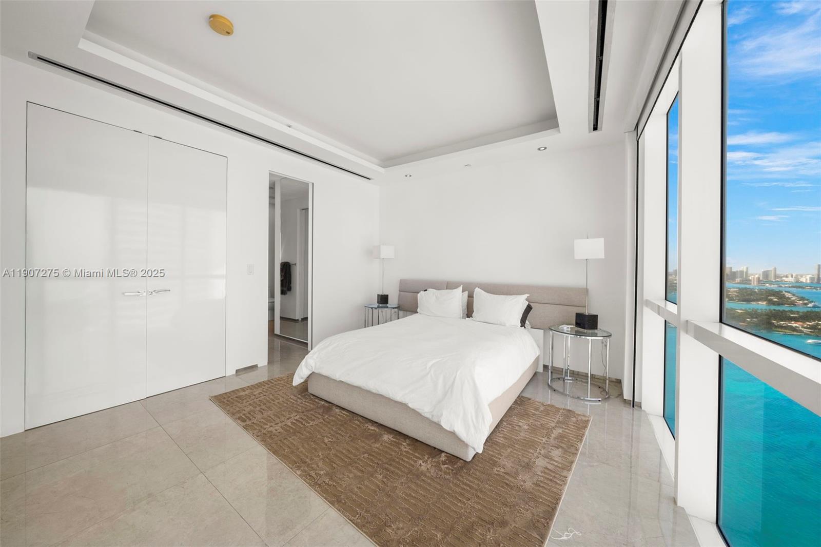 450 Alton Road, Unit PH4104 Miami Beach, FL 33139 - Photo 39 of 84 a bedroom with a large bed and a large window