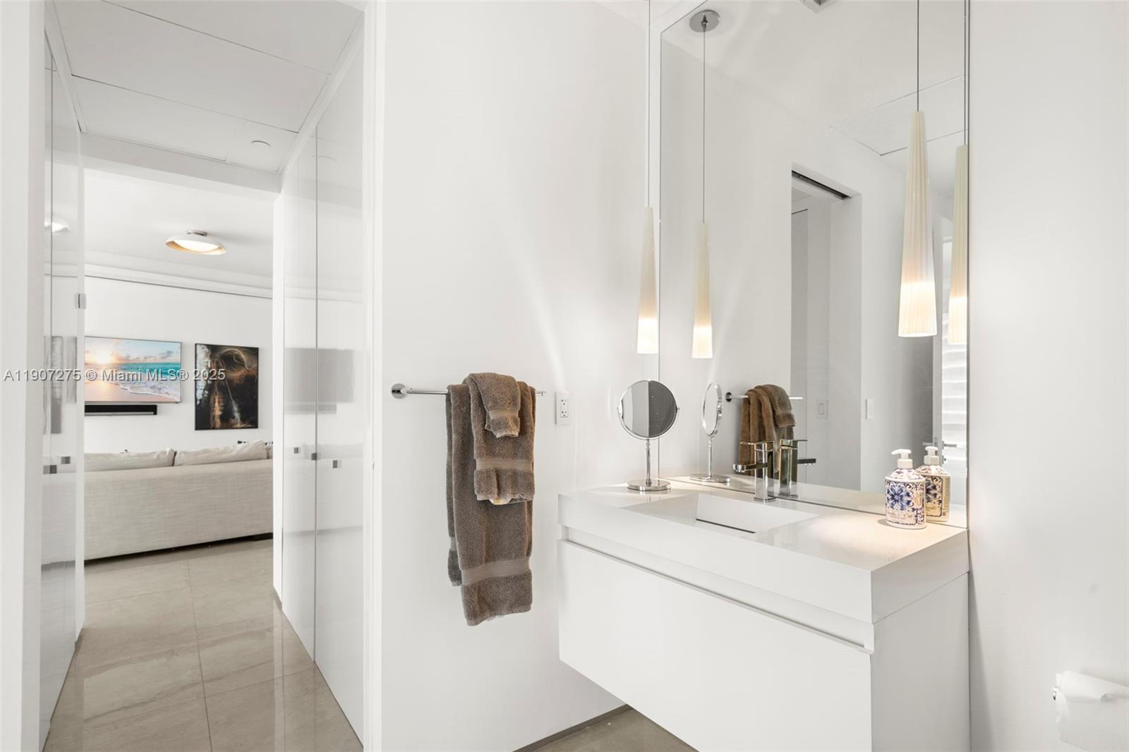 450 Alton Road, Unit PH4104 Miami Beach, FL 33139 - Photo 40 of 84 a bathroom with a sink and a mirror