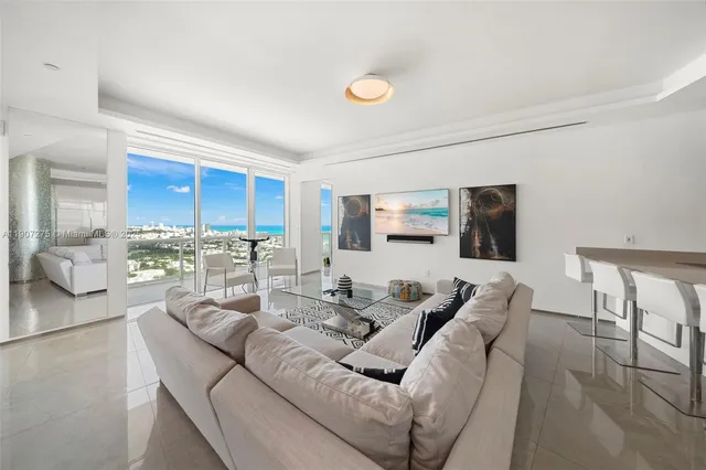 a living room with furniture wooden floor and a flat screen tv