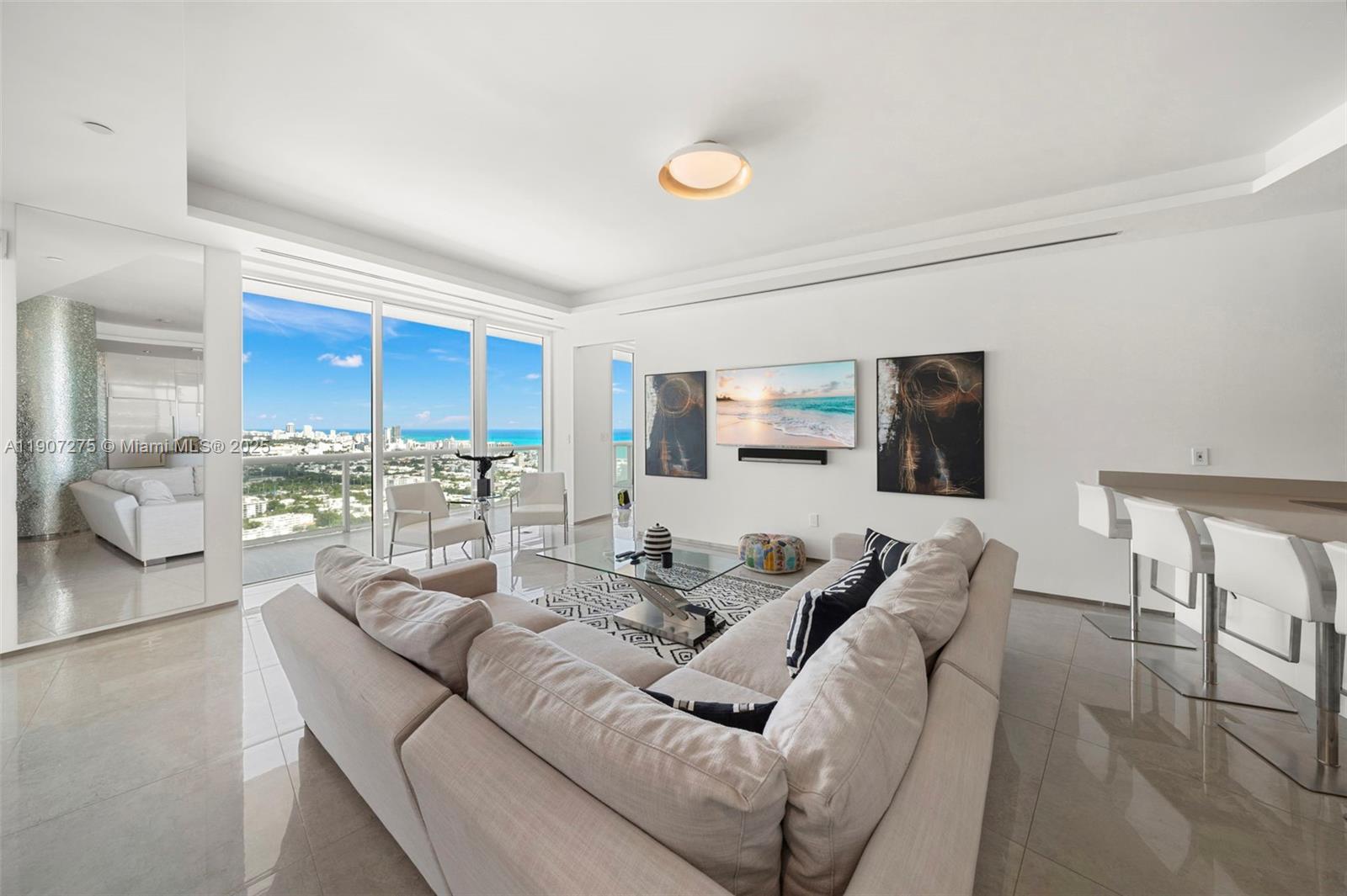 450 Alton Road, Unit PH4104 Miami Beach, FL 33139 - Photo 5 of 84 a living room with furniture wooden floor and a flat screen tv