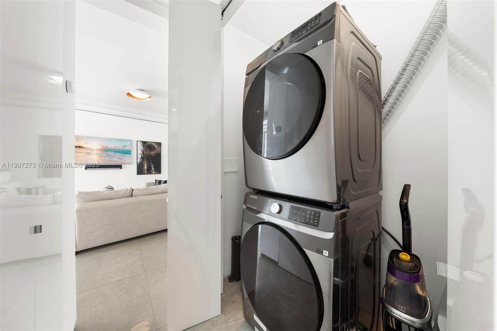 450 Alton Road, Unit PH4104 Miami Beach, FL 33139 - Photo 59 of 84 a view of washer and dryer with kitchen in the background