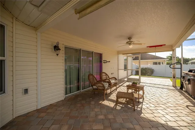 a view of a patio with table and chairs and potted plants