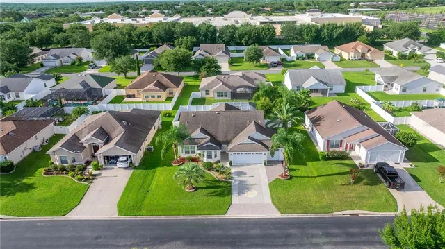 an aerial view of multiple houses with yard