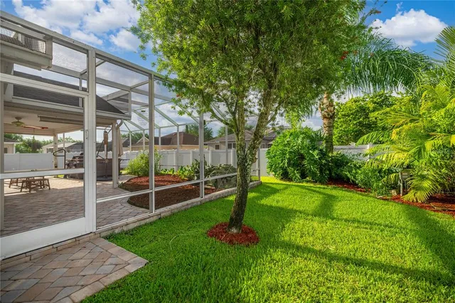 a view of a backyard with table and chairs under an umbrella
