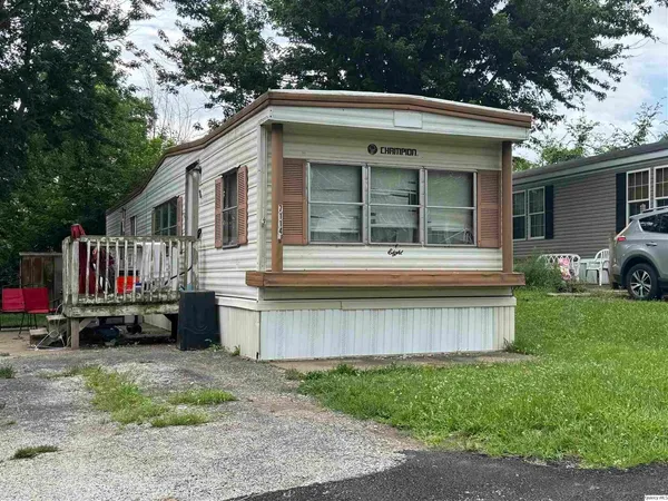 a view of a house with a yard and roof