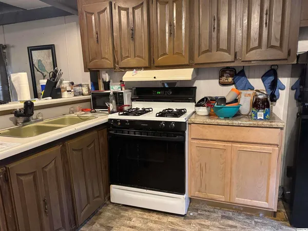 a kitchen with stainless steel appliances granite countertop a stove a refrigerator and a sink