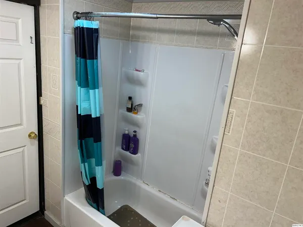 a bathroom with a shower and a sink