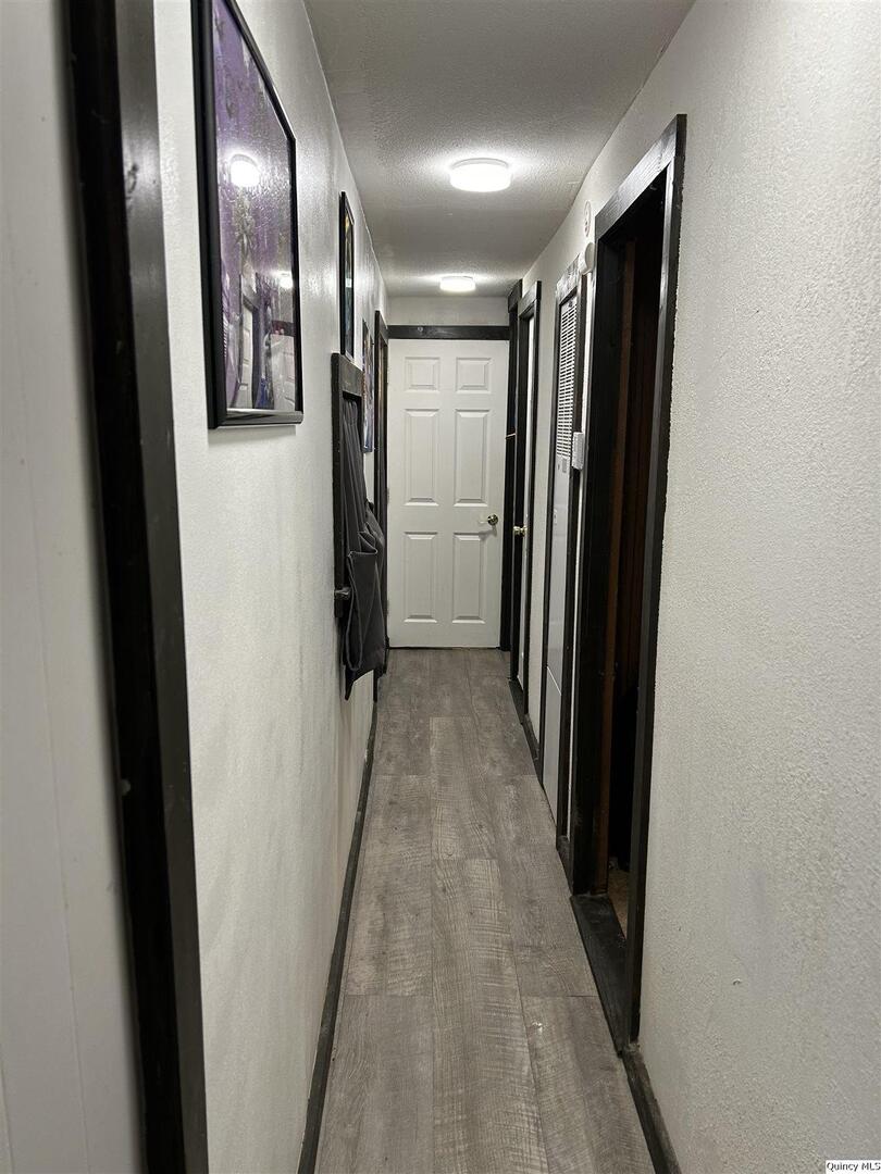 7114 Timber Ridge South Quincy, IL 62305 - Photo 7 of 9 a view of hallway with stainless steel appliances wooden floor and staircase