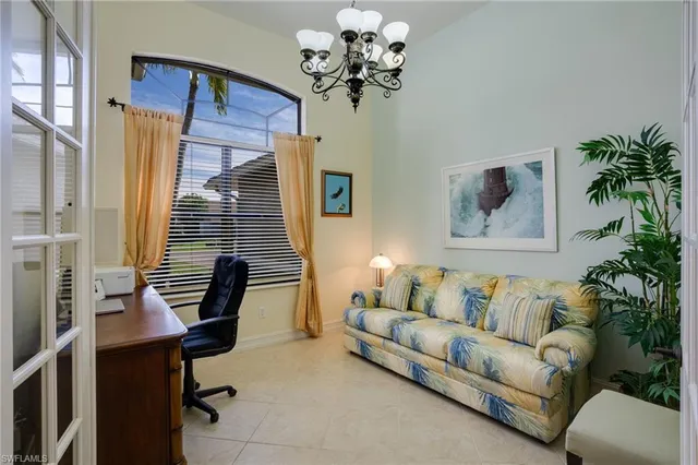 a dining room with furniture water view and a floor to ceiling window
