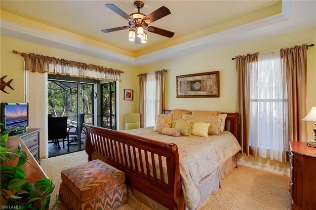 a living room with furniture chandelier and a window