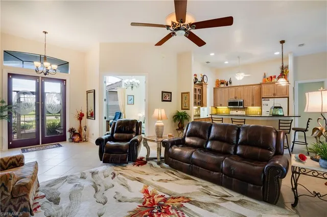 a living room with furniture ceiling fan and a rug